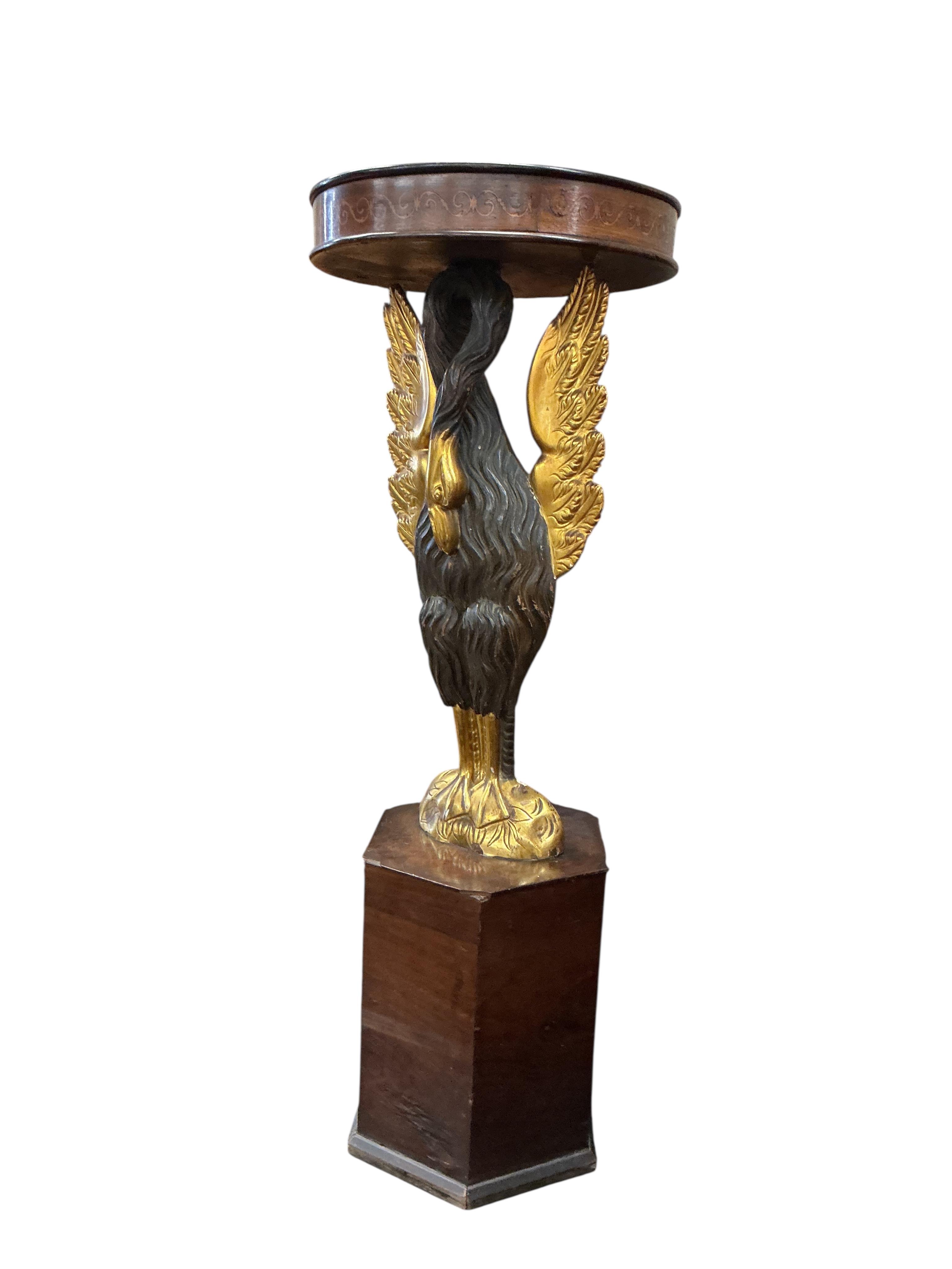 An Empire style carved wood phoenix occasional table on hexagonal plinth, height 99cm